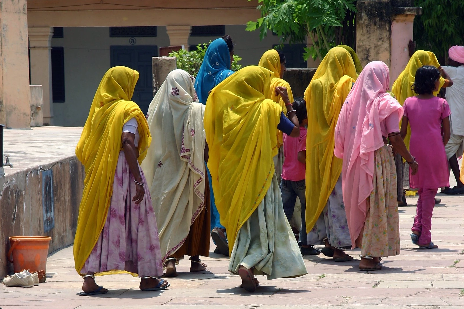 Des femmes en saris colorés traversant une cour à Orchha