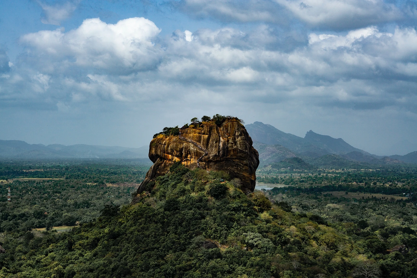 Sigiriya rock fortress rising above green plains